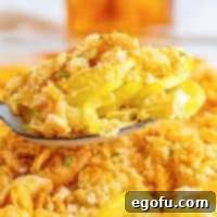 Close up looking at a bite of delicious, squash casserole.