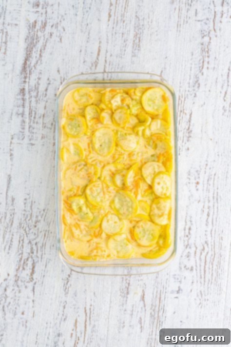 Squash casserole mixture in a baking dish before topping.