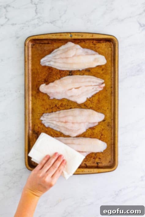 Golden Crispy Catfish 12 patting catfish dry with paper towels.