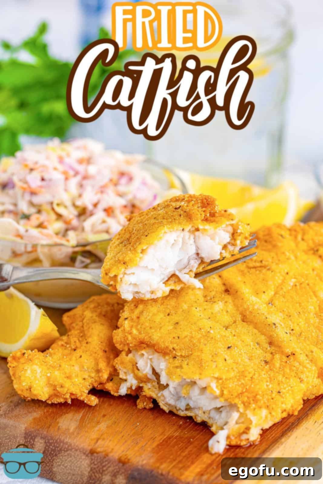 Golden Crispy Catfish 3 A bite of fried catfish sitting on the rest of the fried fillet, showcasing its crispy texture.