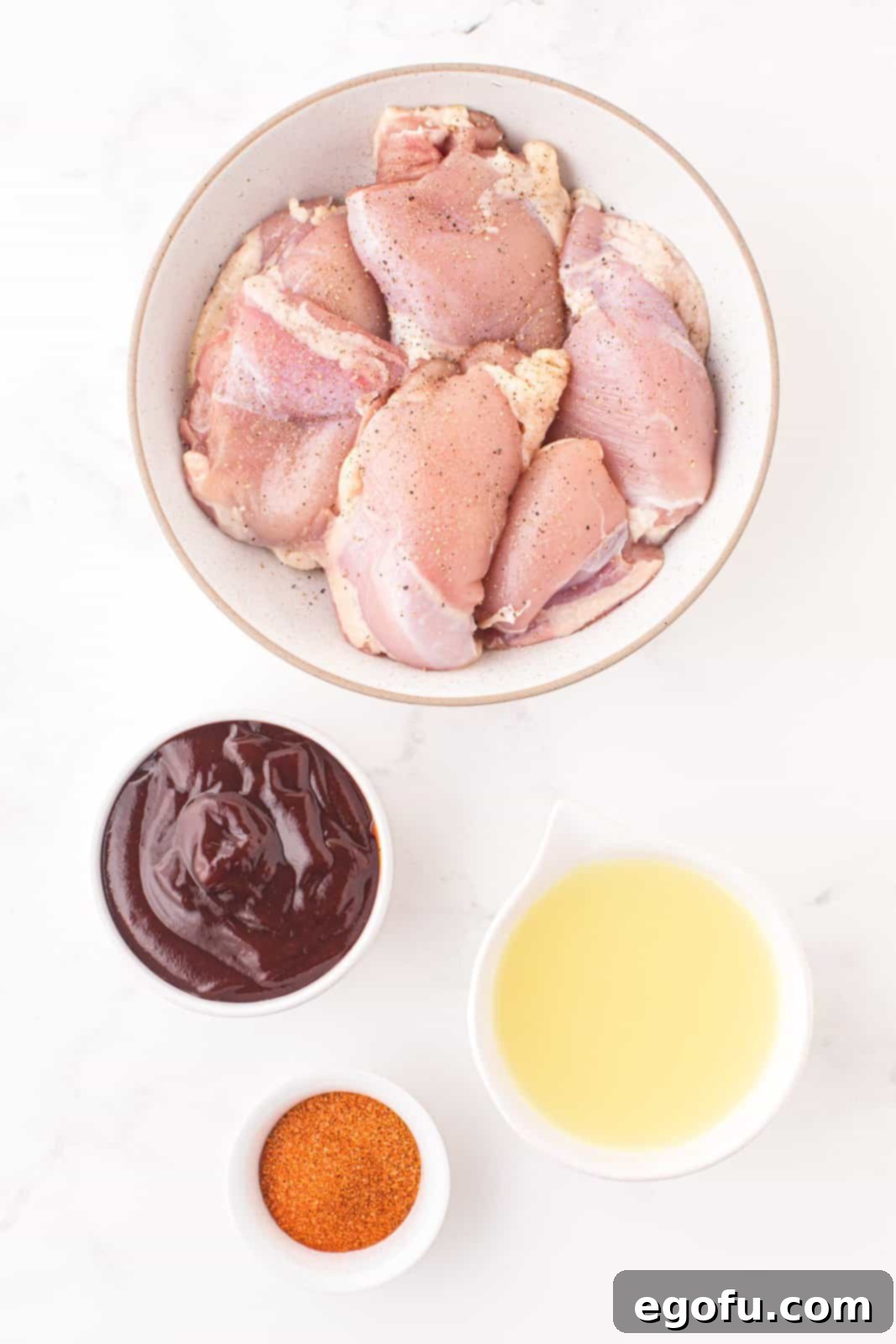 Boneless, skinless chicken thighs, bbq seasoning, chicken stock, and bbq sauce.