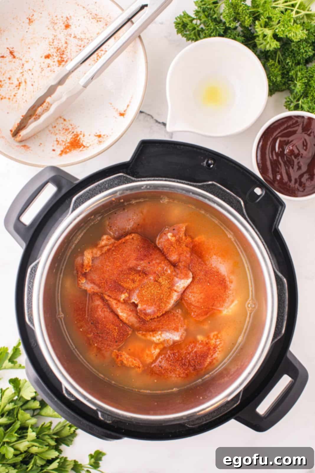 An Instant Pot with chicken and chicken stock.