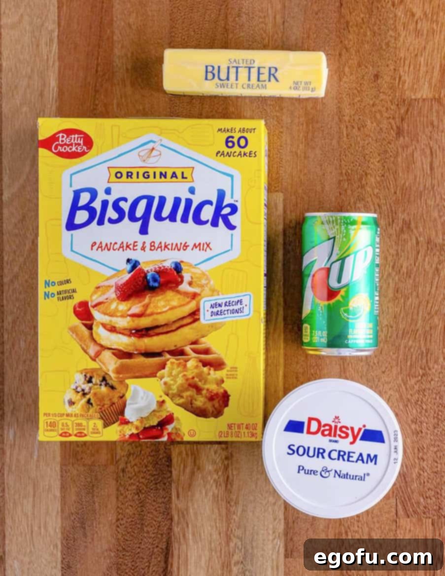 A visual lineup of the four simple ingredients: Bisquick, sour cream, 7Up, and a stick of butter.