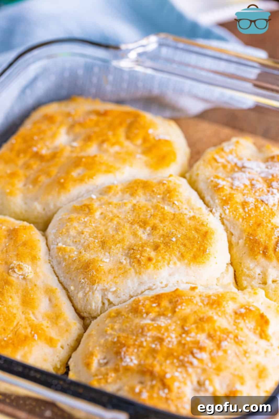 A baking dish filled with freshly baked, golden 7Up biscuits, glistening with butter.