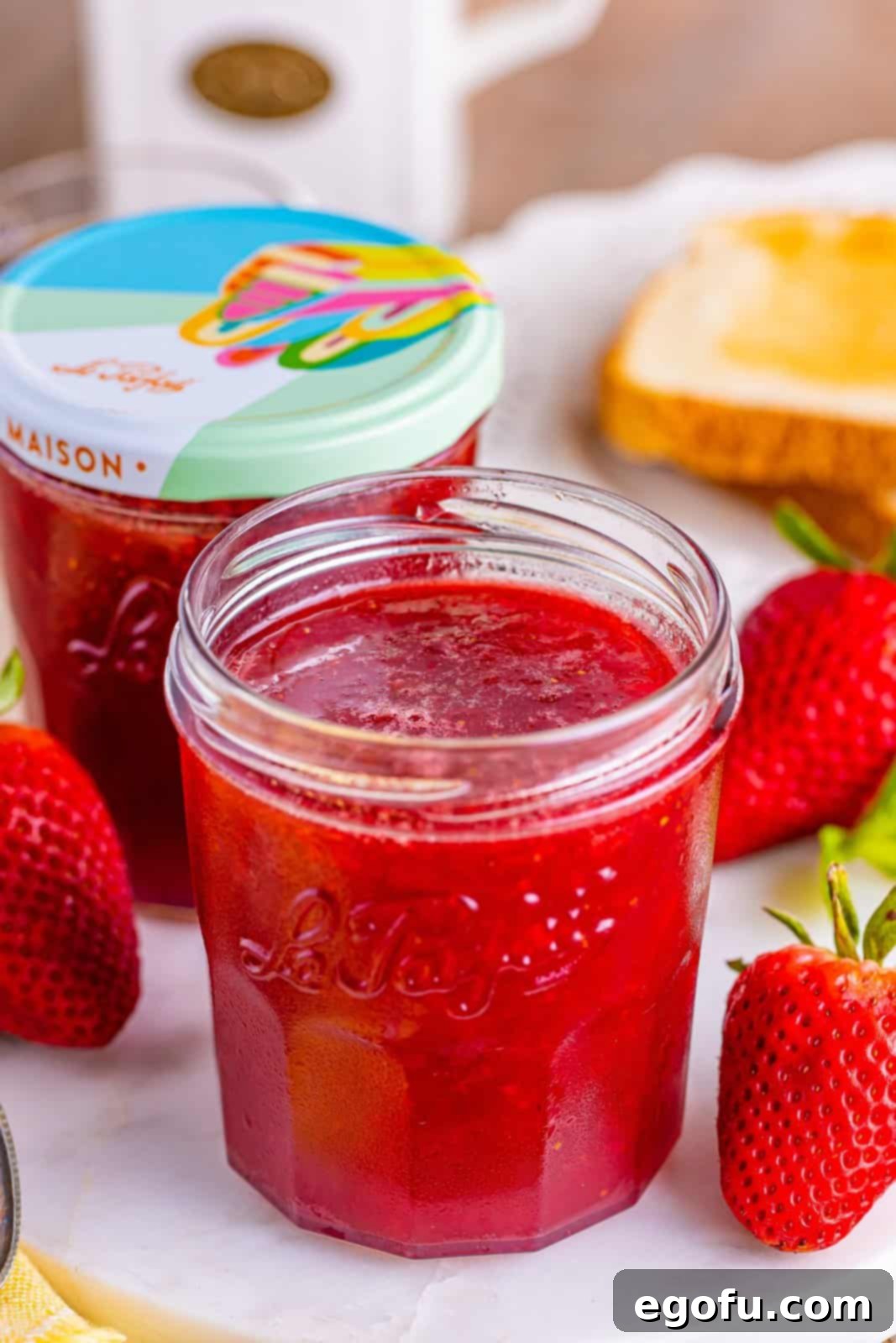 From Garden or Freezer: Homemade Strawberry Jam 11 An open and closed jar of Strawberry Jam.