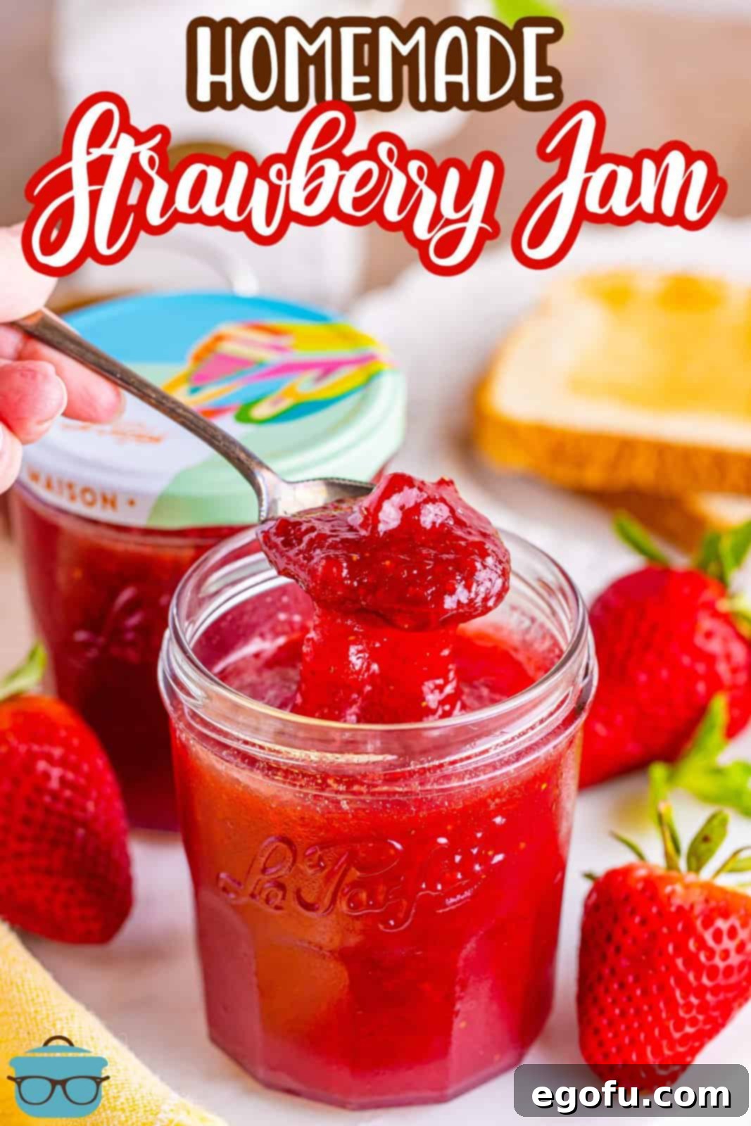 From Garden or Freezer: Homemade Strawberry Jam 9 One open jar of strawberry jam with a spoon holding some above it and a closed jar behind it.