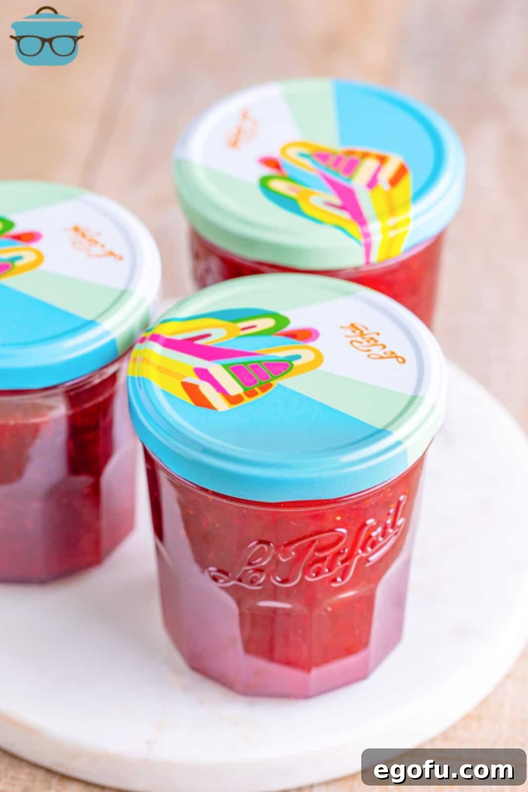 From Garden or Freezer: Homemade Strawberry Jam 8 Three jars of homemade strawberry jam with lids on top.