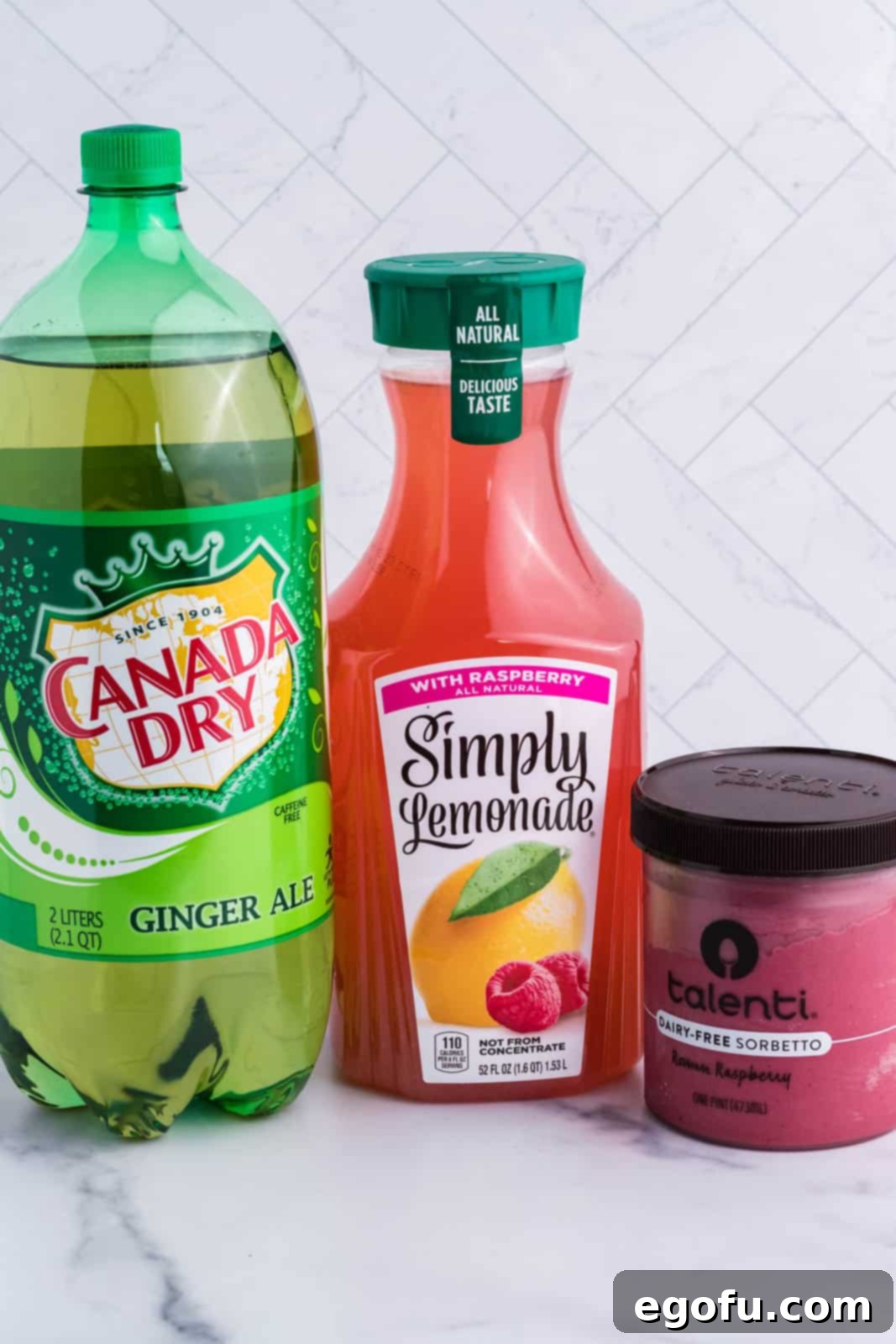 Stork's Sipper 4 The three essential ingredients for Baby Shower Punch: Raspberry lemonade, ginger ale, and raspberry sherbet, neatly arranged.