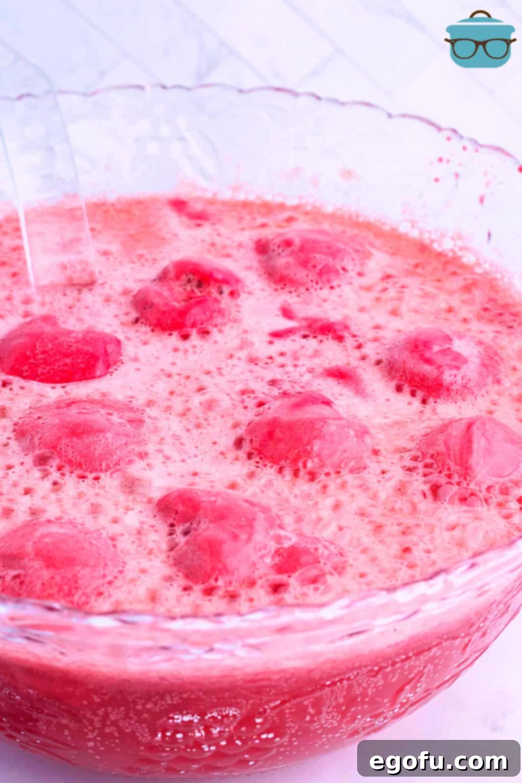 Stork's Sipper 8 A large punch bowl filled with pink Baby Shower Punch, ready for guests.