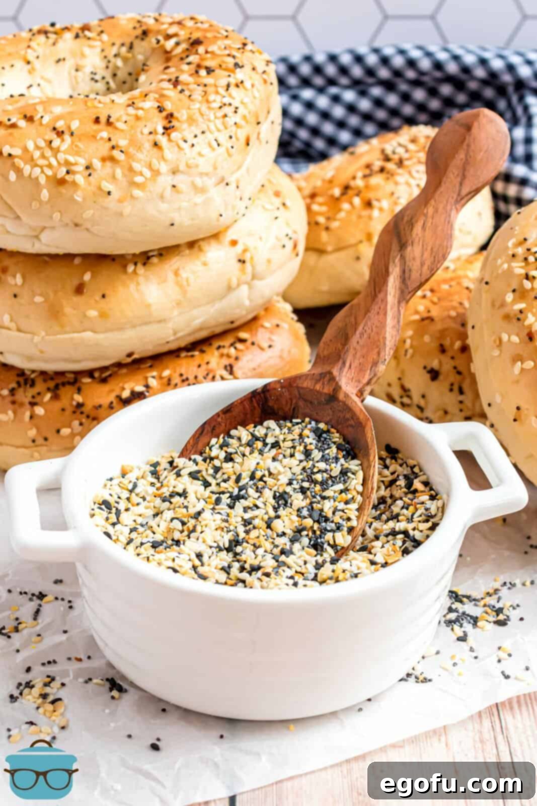 A small ramekin of Everything But The Bagel Seasoning and a wooden spoon in the bowl.