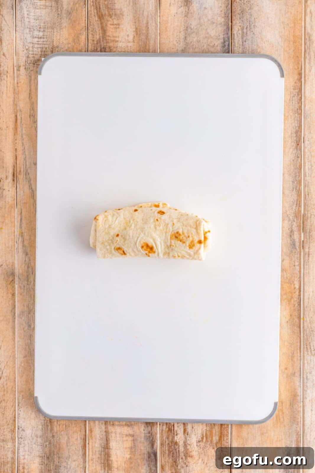 A perfectly rolled Southwest Chicken Wrap, forming a neat, portable package.