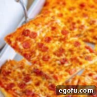 Close up looking at a slice of Rectangle School Pizza.