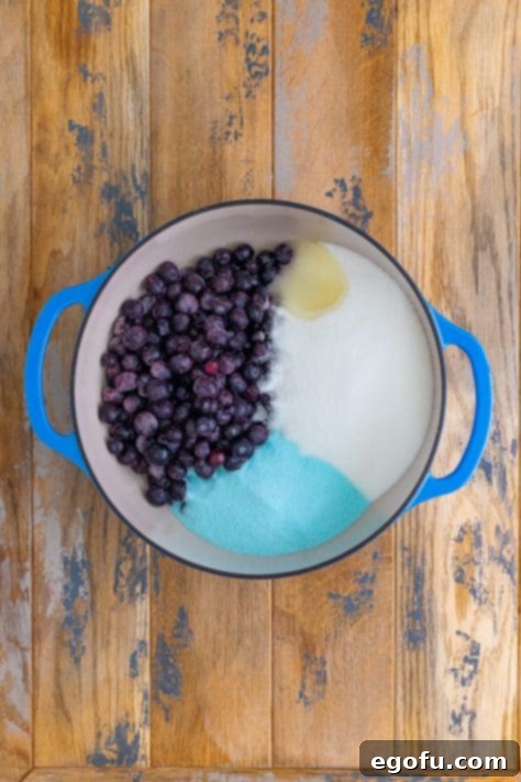 frozen blueberries, sugar, berry blue jell-o and lemon juice added to a large pot.