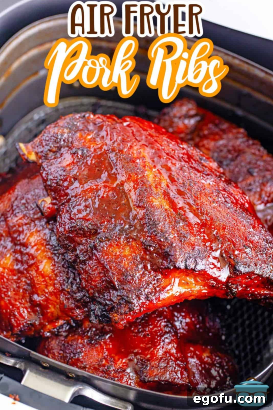 A rack of seasoned ribs nestled in the Air Fryer basket before cooking.