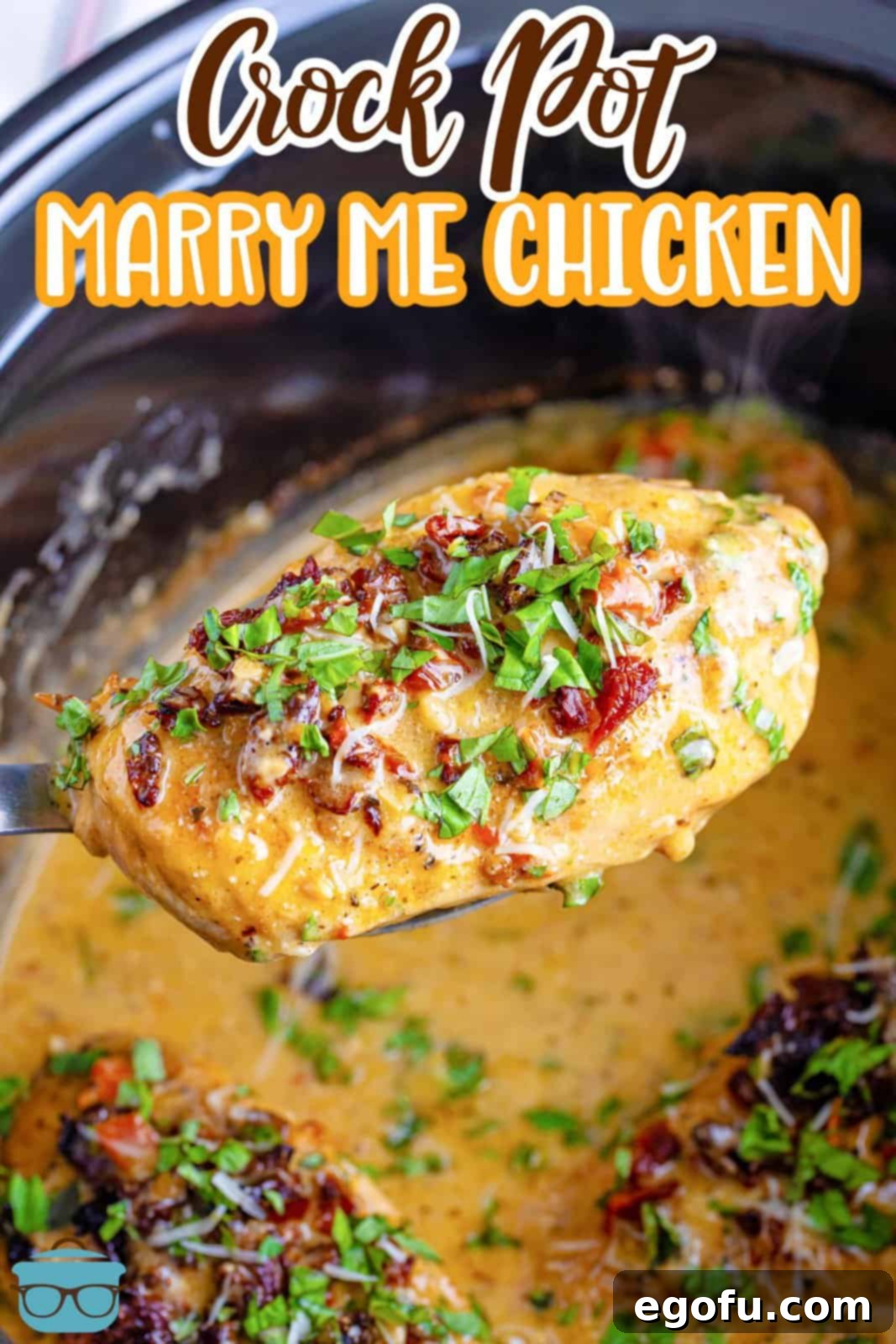 Slow Cooker Love Potion Chicken 3 A piece of Marry Me Chicken on a serving utensil over a Crock Pot.