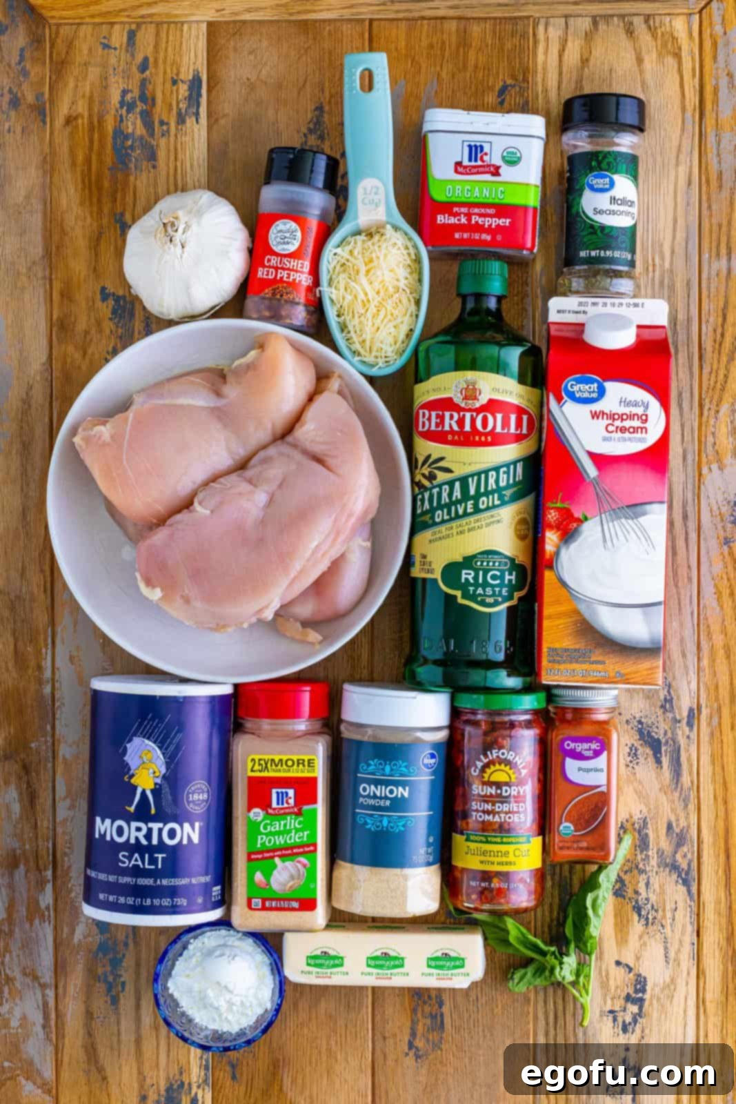 Slow Cooker Love Potion Chicken 4 Boneless, skinless chicken breasts, salt, garlic powder, onion powder, black pepper, olive oil, butter, chicken broth, cornstarch, heavy cream, cloves garlic, Italian seasoning, red pepper flakes, sweet paprika, chopped sundried tomatoes, freshly grated parmesan cheese, and fresh basil leaves.