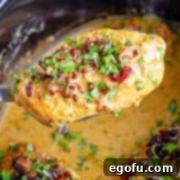 Slow Cooker Love Potion Chicken 8 Closely looking at a piece of Marry Me Chicken.