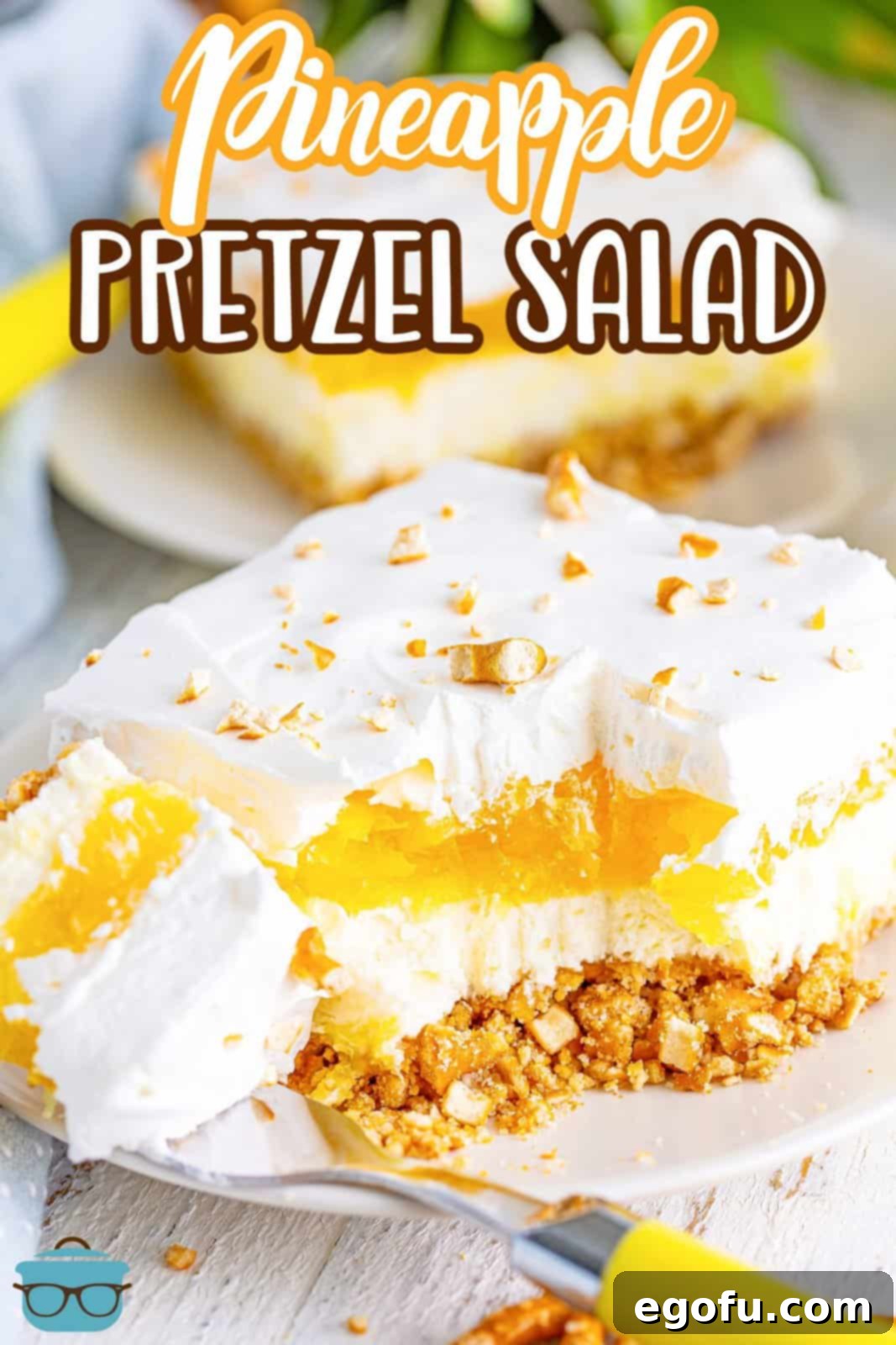 A square of Pineapple Pretzel Salad with a bite missing.