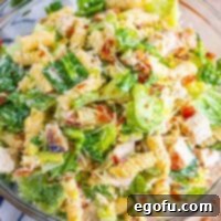 Looking down on a bowl of chicken Caesar pasta salad.