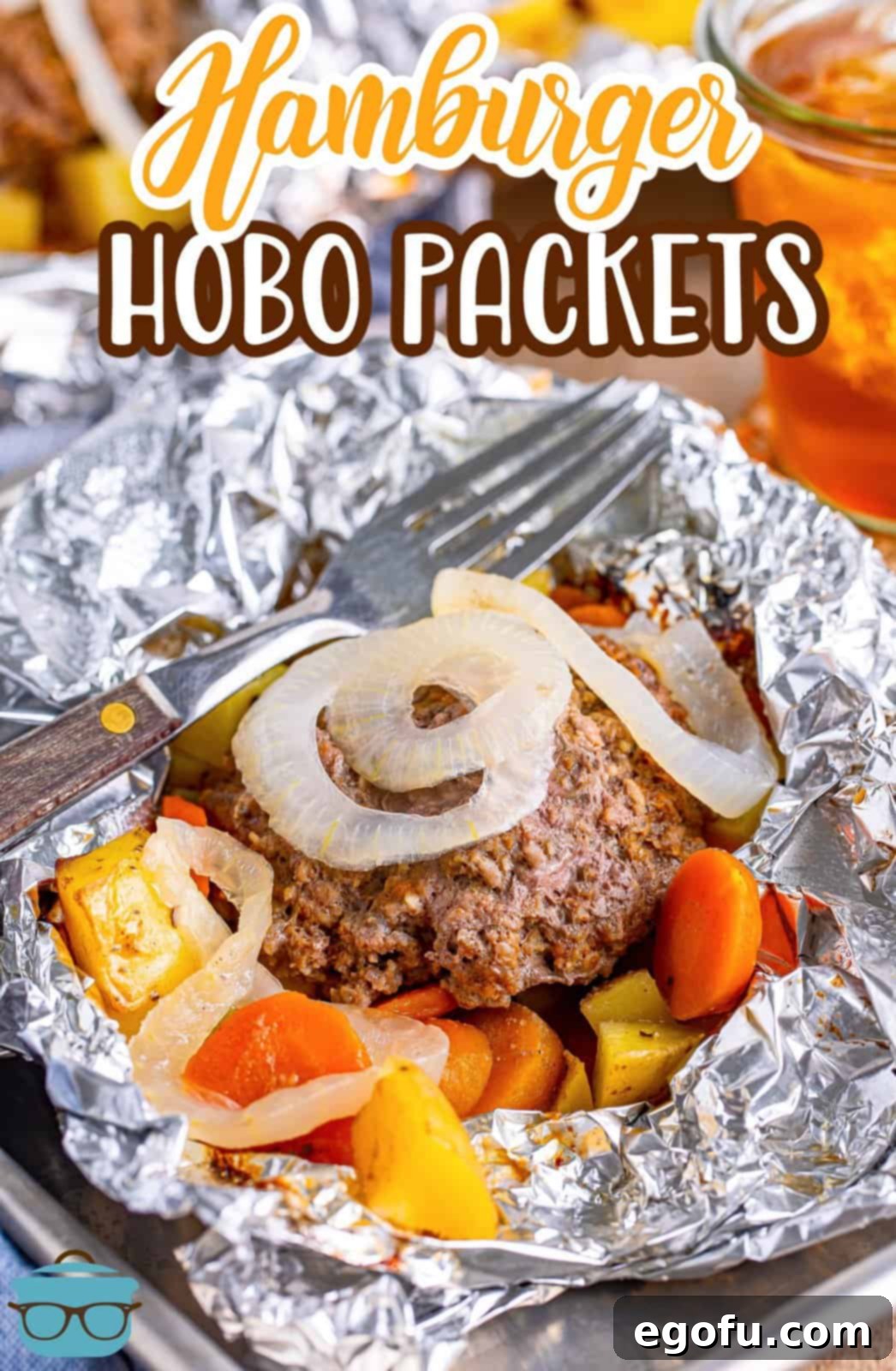 A hamburger hobo packet with onions, carrots, and potatoes.