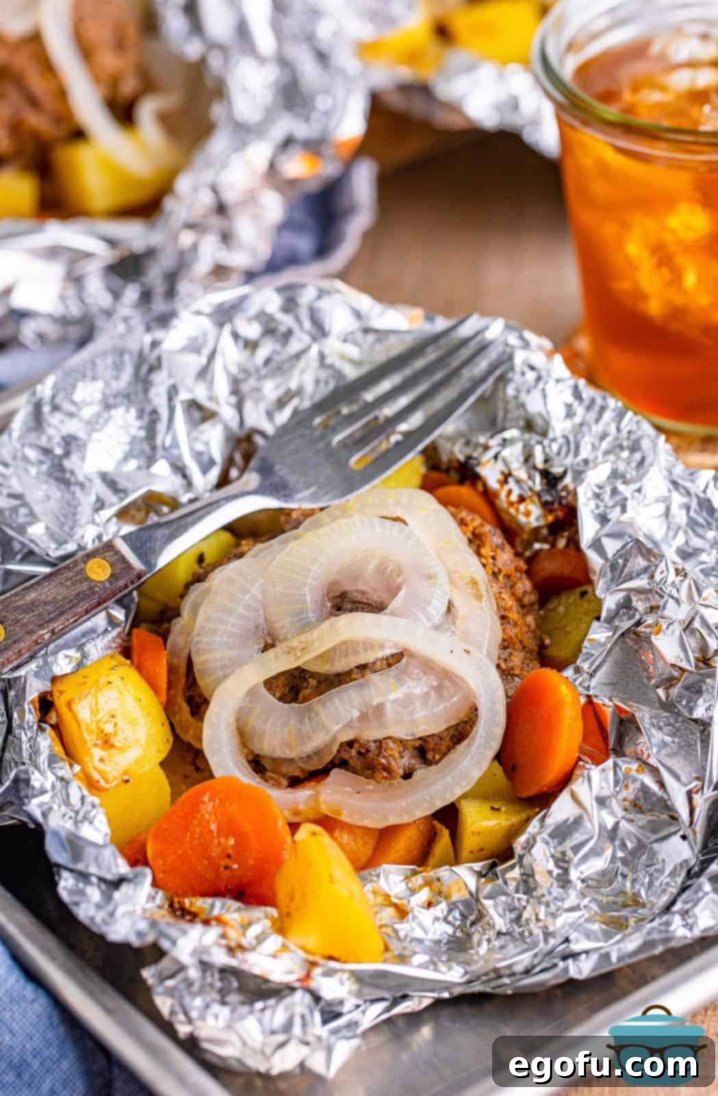 Closely looking at a Hamburger Hobo Pack with a fork.