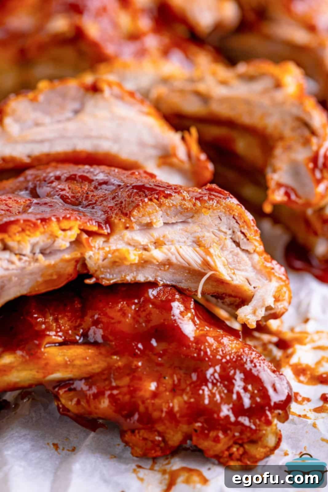 Closely looking at the meat on a rack of ribs.