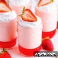 Looking down on a couple jars of strawberry Jell-O parfait.