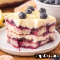 Close up looking at a piece of lemon blueberry tiramisu with a bite taken out.