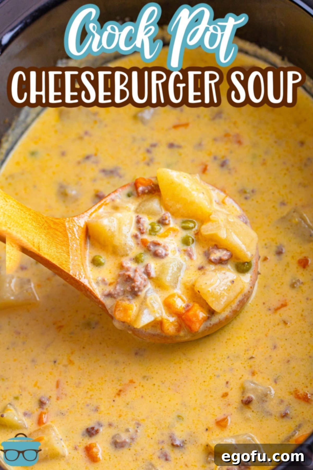 A wooden ladle scooping up cheeseburger soup from the slow cooker, showing its rich, creamy texture.