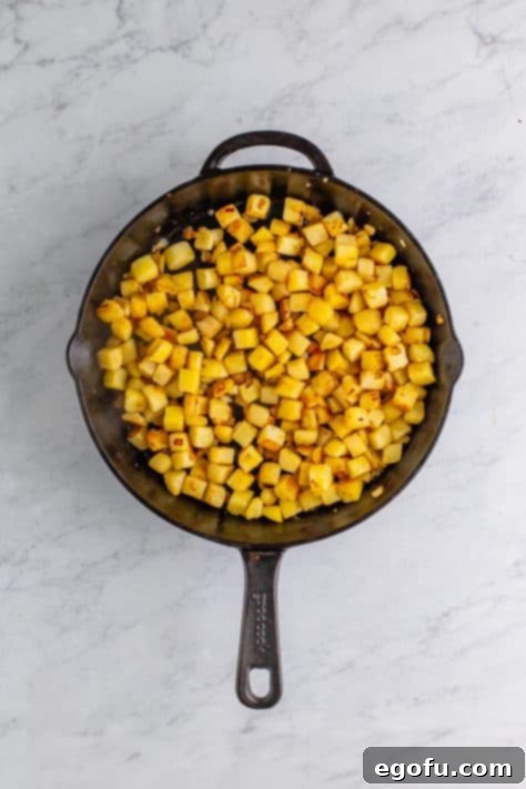 Homemade Corned Beef Hash 9 A skillet with diced, cooked potatoes.