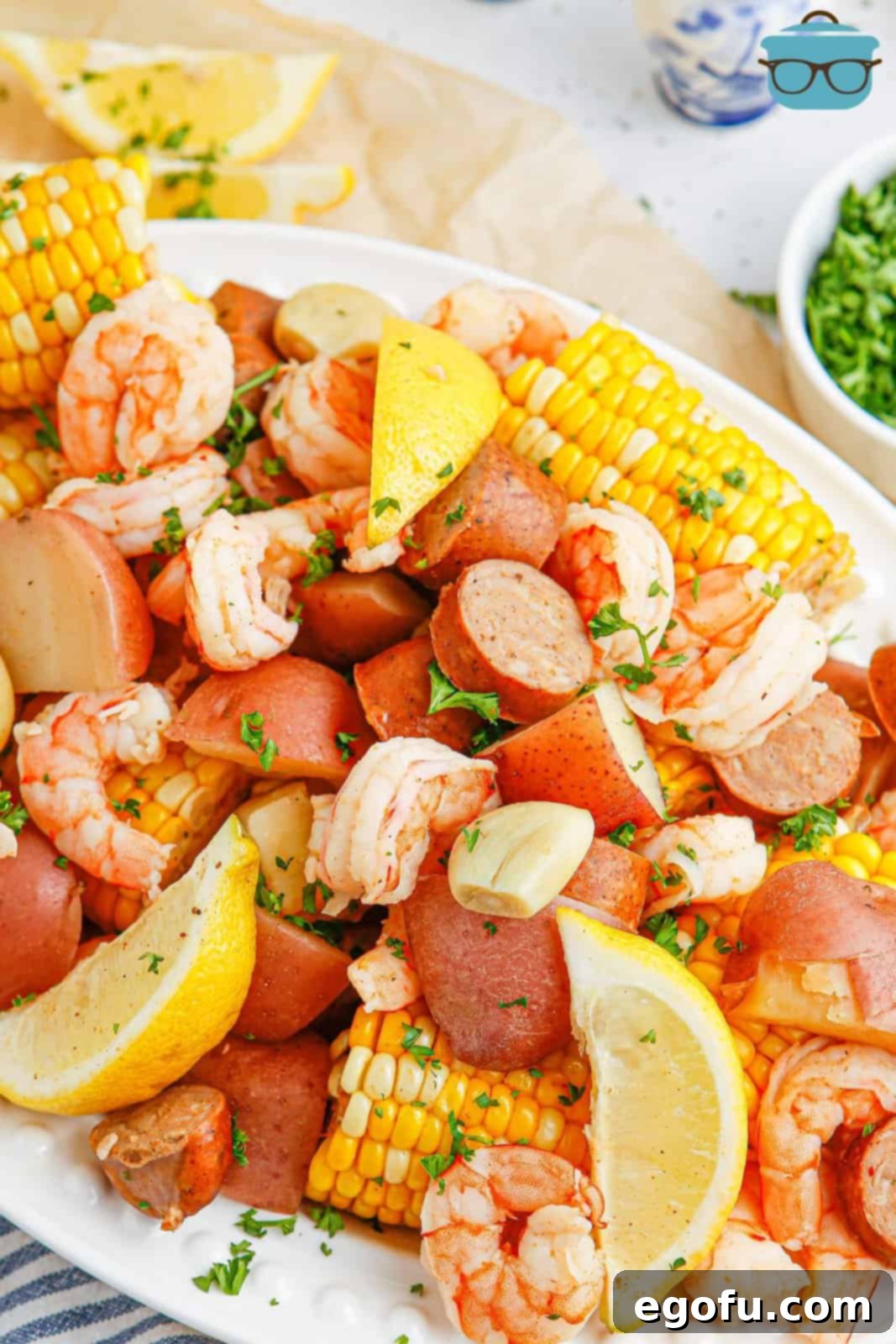 Looking closely at a Shrimp boil dinner on a platter.