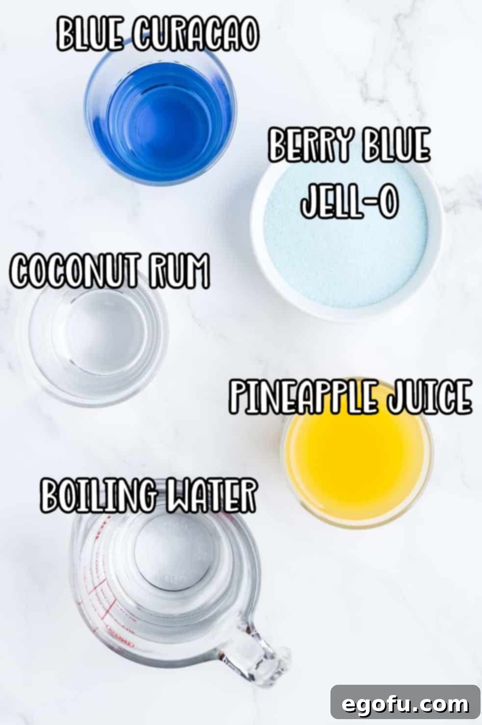 Individual ingredients for Blue Hawaii Jell-O shots: Berry Blue Jell-O mix, a measuring cup with water, a bottle of coconut rum, pineapple juice, and blue curaçao bottles.