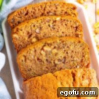A beautifully baked loaf of Zucchini Bread, sliced, ready to serve.