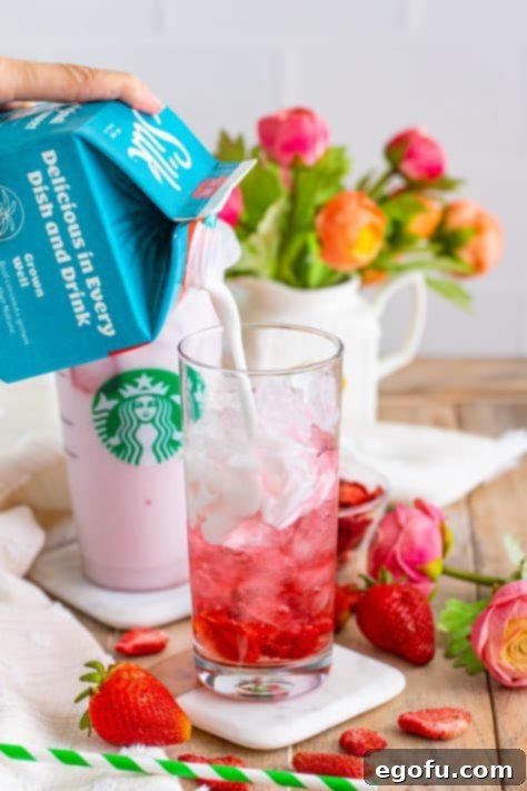 Starbucks' Iconic Pink Drink 10 Coconut milk being poured in the glass.