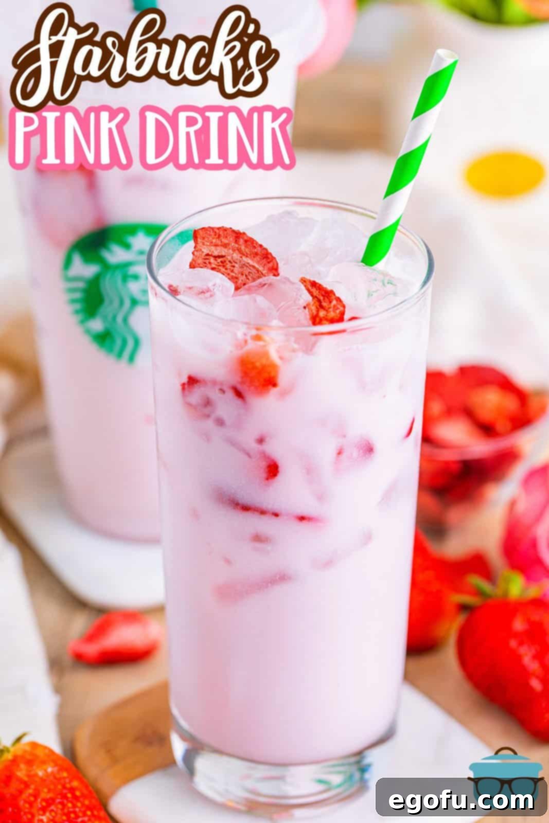 Starbucks' Iconic Pink Drink 3 Closely looking at a Starbucks Pink Drink in a glass with a green and white straw.