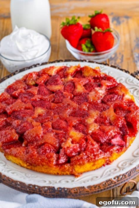 A freshly baked Strawberry Upside Down Cake on a serving plate.
