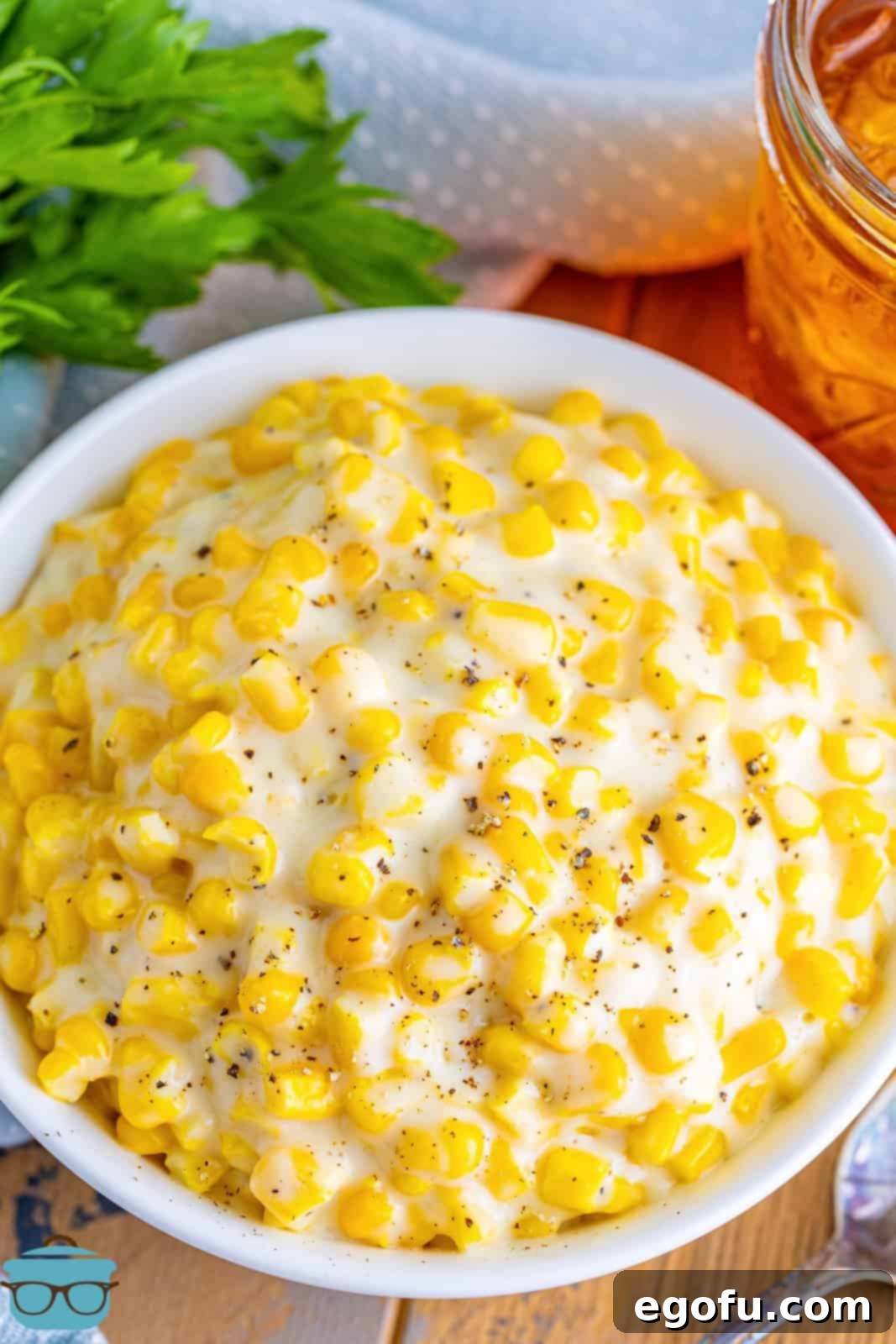A white serving bowl of Creamed Corn.