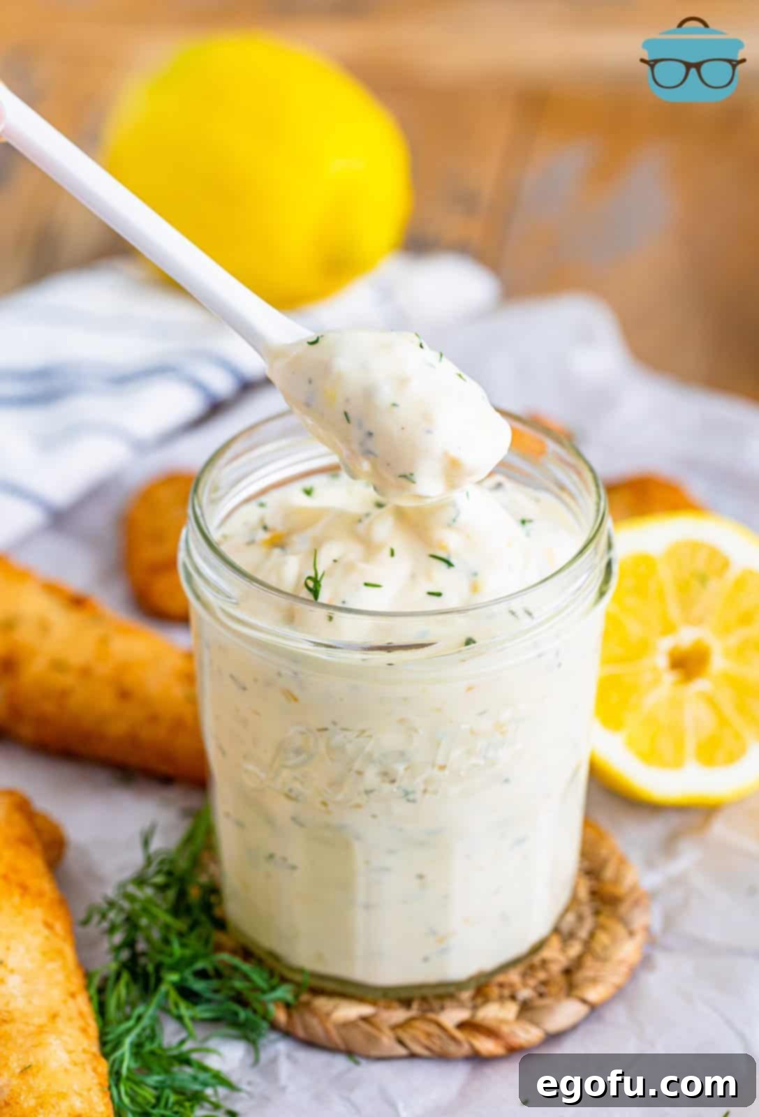 Tangy Homemade Tartar Sauce 2 A spoon holding some fresh made homemade tartar sauce, ready to be served with seafood.