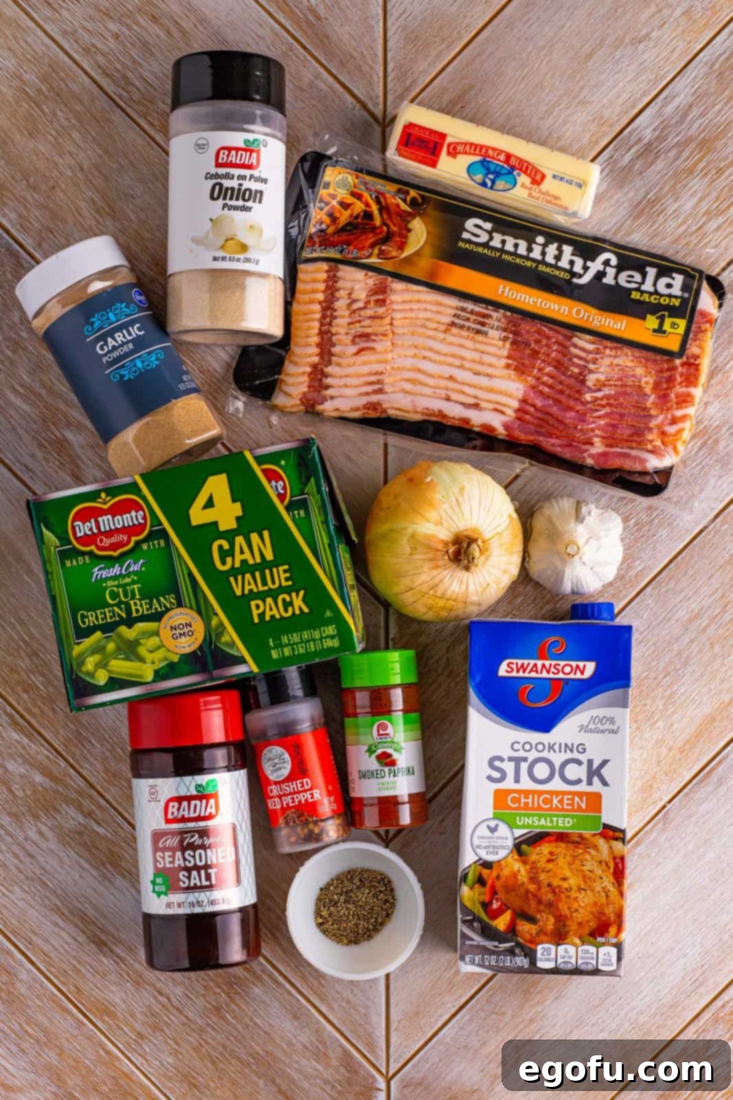 A vibrant collage displaying all the fresh ingredients for slow cooker green beans: bacon, onion, garlic, chicken stock, green beans, and a selection of spices and butter.