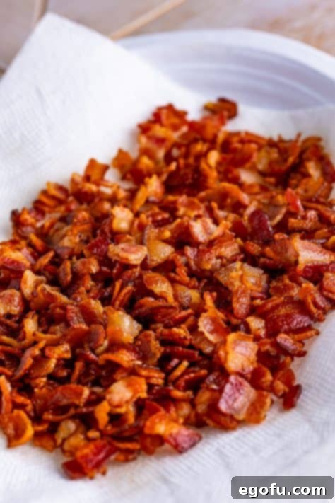 cooked bacon pieces on a paper towel.