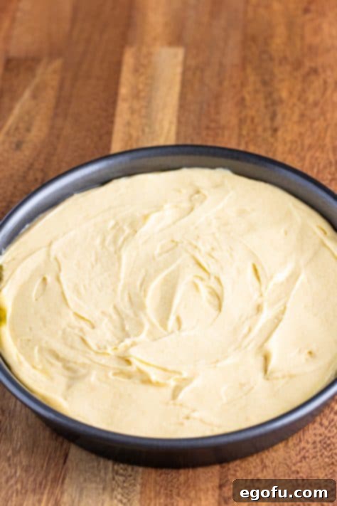 Unbaked banana upside down cake in a pan with the cake batter spread over the banana layer.
