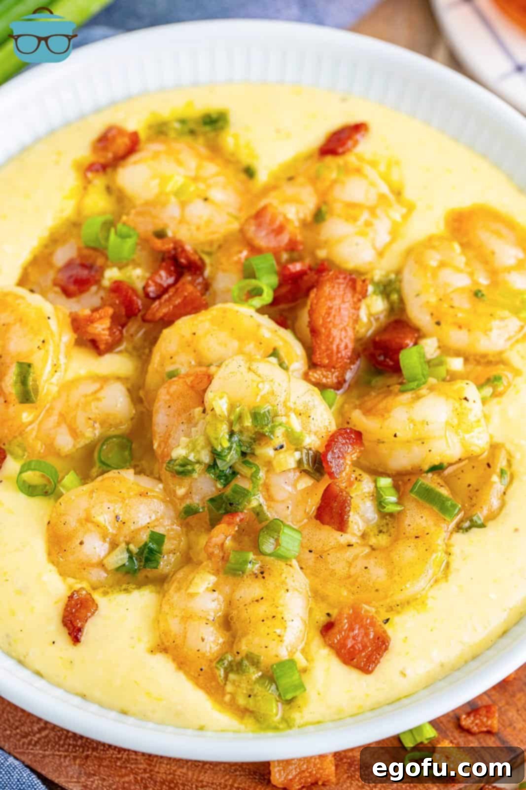 Bayou Bounty Shrimp and Grits 2 Looking down on a serving bowl of shrimp and grits with garnishes.