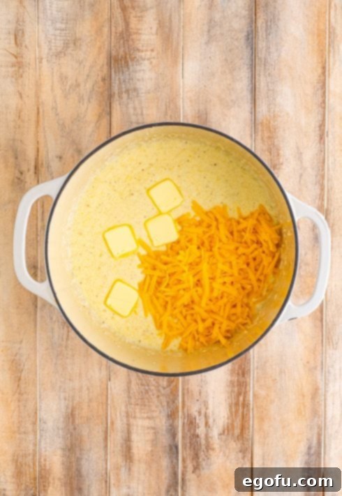 Bayou Bounty Shrimp and Grits 12 Cheese and butter in a liquid mixture in a dutch oven.