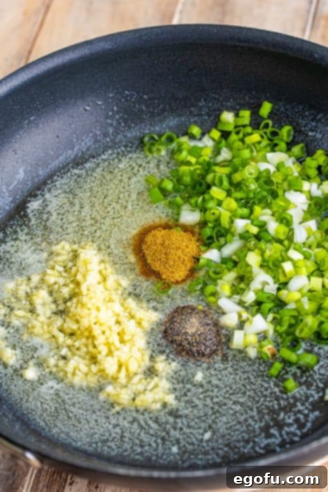 Bayou Bounty Shrimp and Grits 14 Bacon grease with green onions, butter, seasoned salt, and pepper.