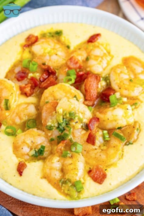 Bayou Bounty Shrimp and Grits 17 Looking down on a serving bowl of shrimp and grits with garnishes.