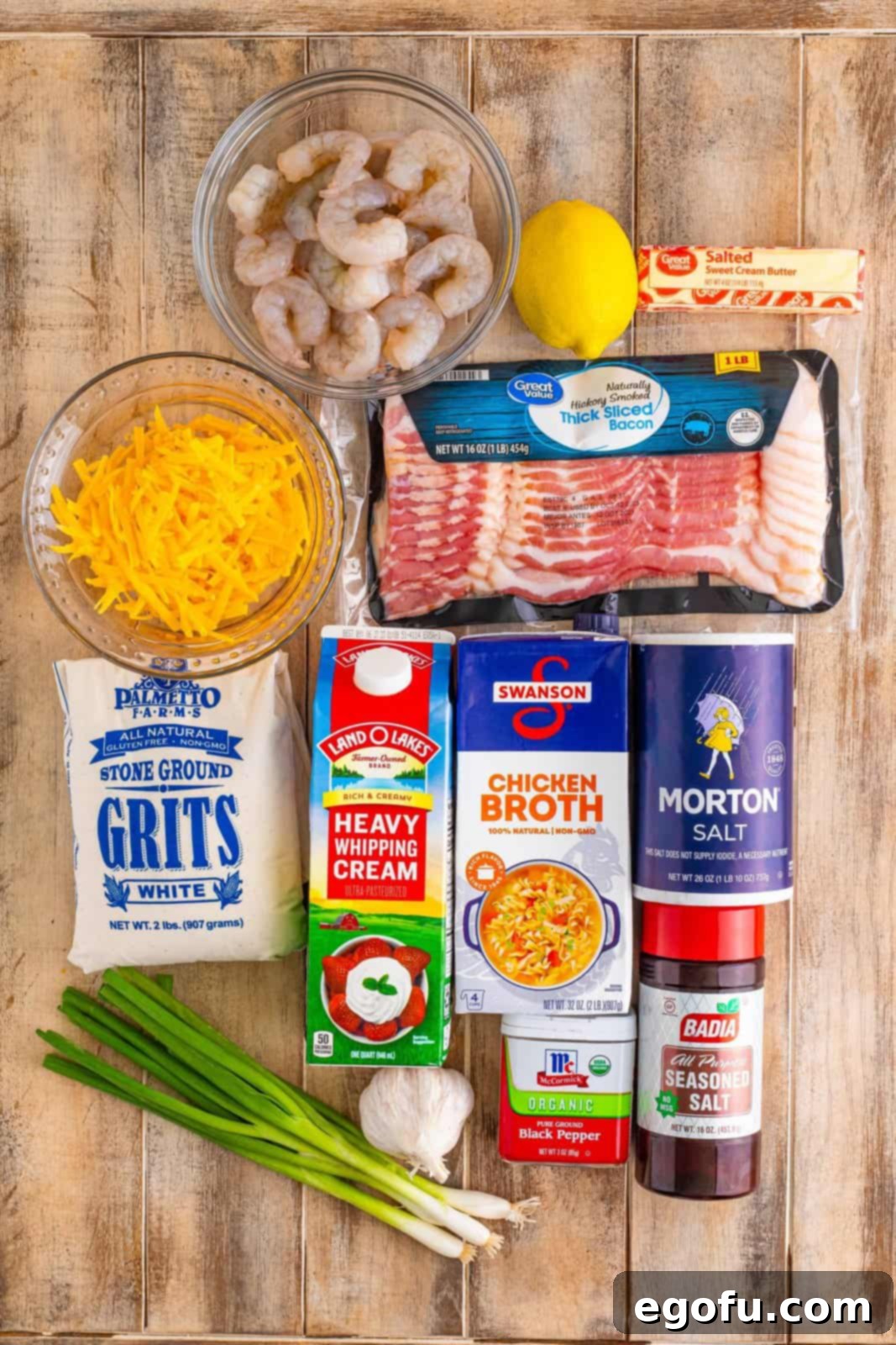 Bayou Bounty Shrimp and Grits 4 Shrimp, stone ground grits, green onions, chicken broth, heavy cream, salt, pepper, shredded cheddar cheese, butter, bacon, green onions, garlic, lemon juice, and seasoned salt.