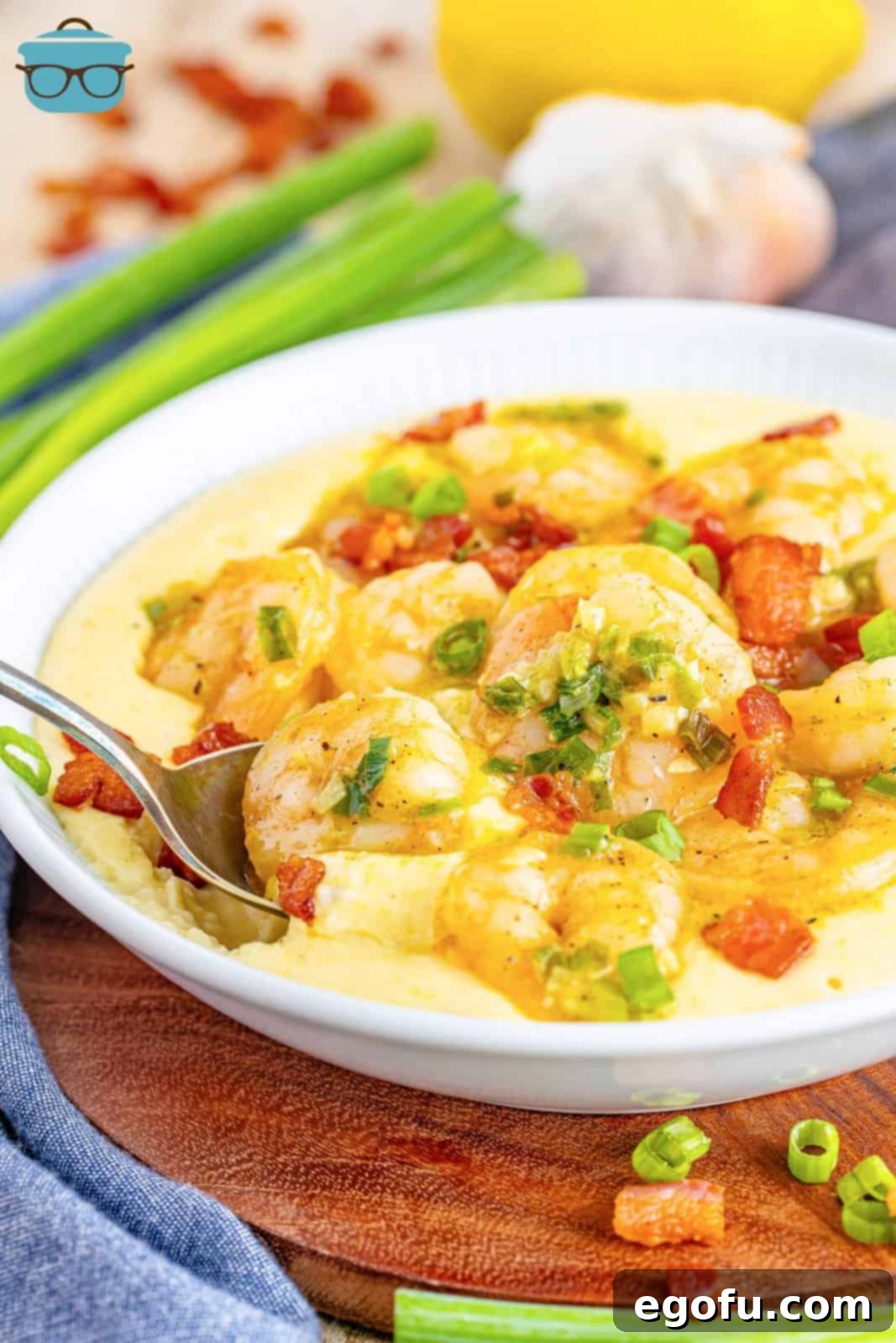 Bayou Bounty Shrimp and Grits 8 A spoon dipping in a bowl of shrimp and grits.