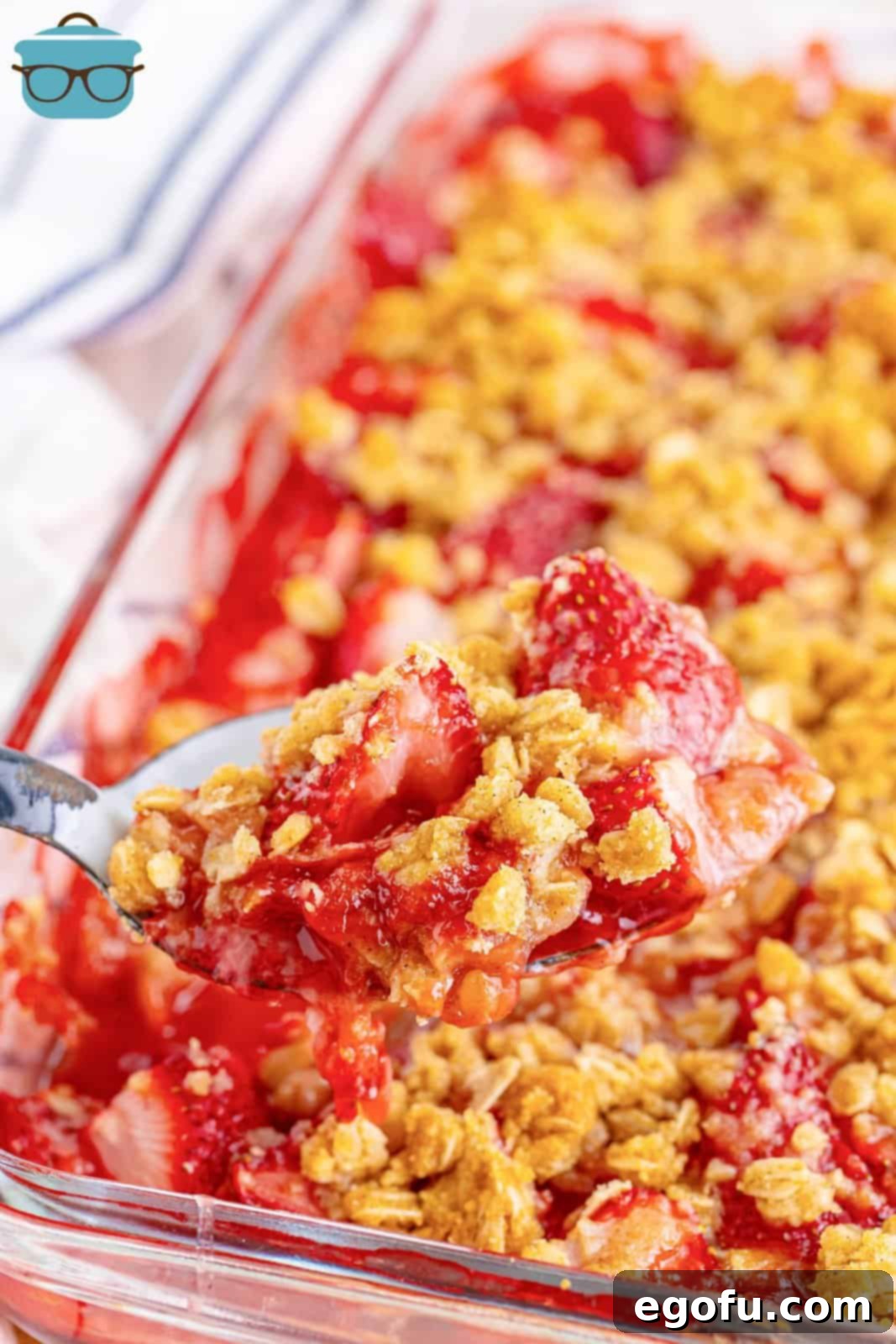 Sweet Strawberry Crumble 2 A utensil getting a scoop of Strawberry Crumble.