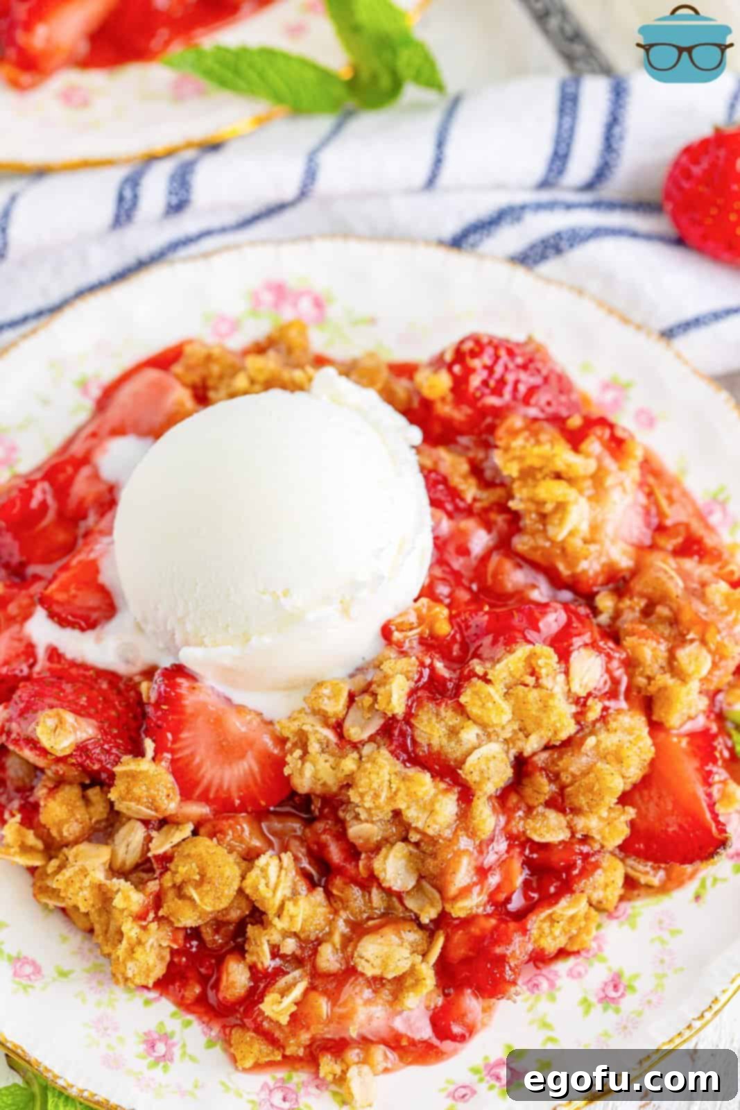 Sweet Strawberry Crumble 8 A dessert plate of strawberry crumble with a dollop of ice cream on top.