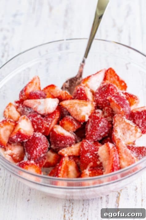 Sweet Strawberry Crumble 10 A mixing bowl of cut strawberries coated in the cornstarch, sugar, lemon juice, and vanilla.